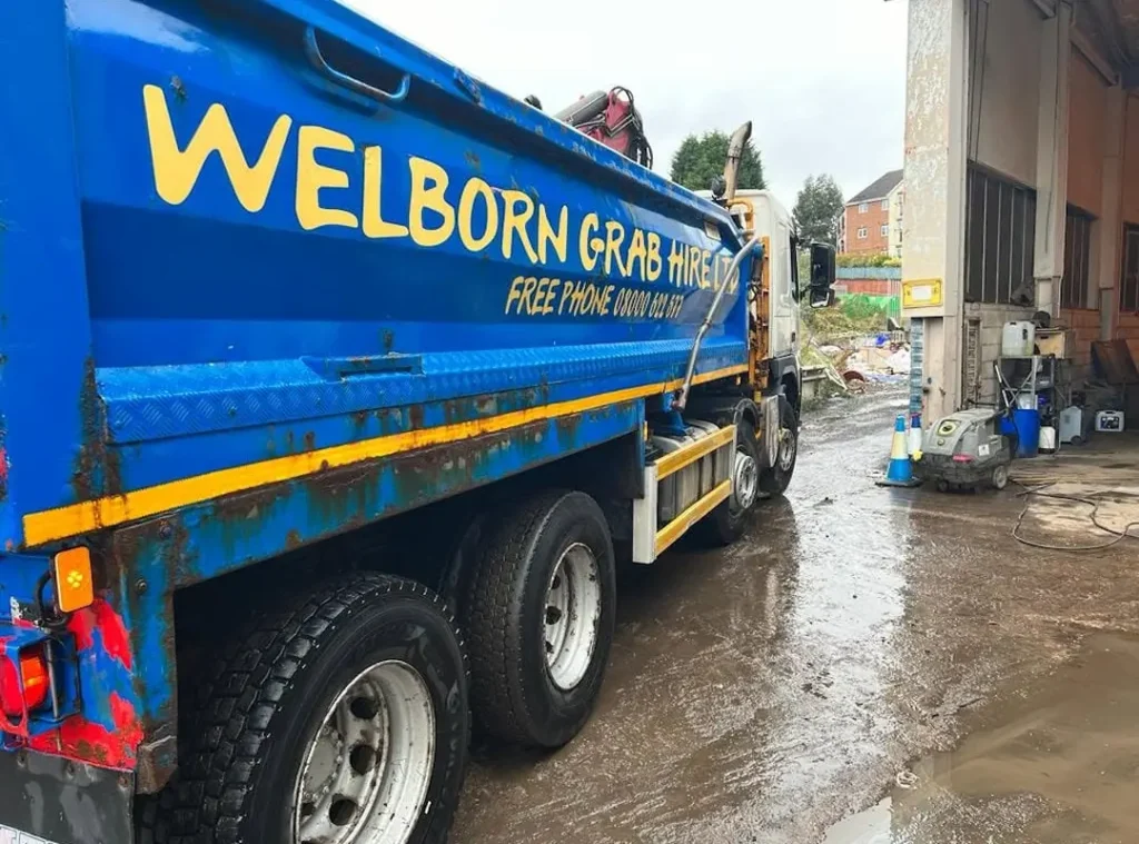 a blue truck with yellow writing on it
