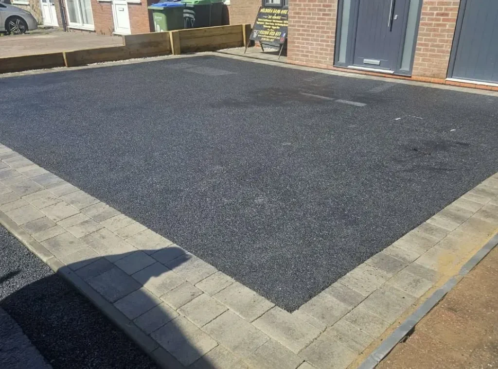 a driveway with a brick building
