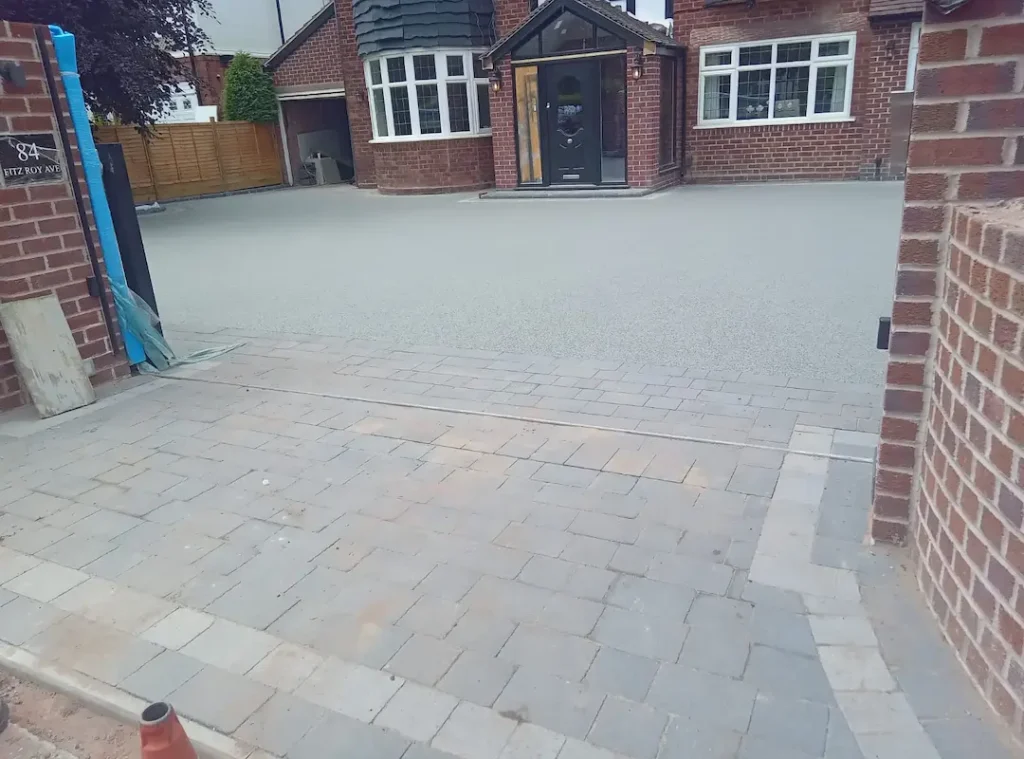a brick driveway with a brick house and a door